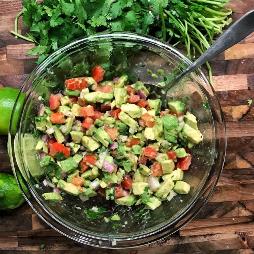 guacamole salad on cutting board