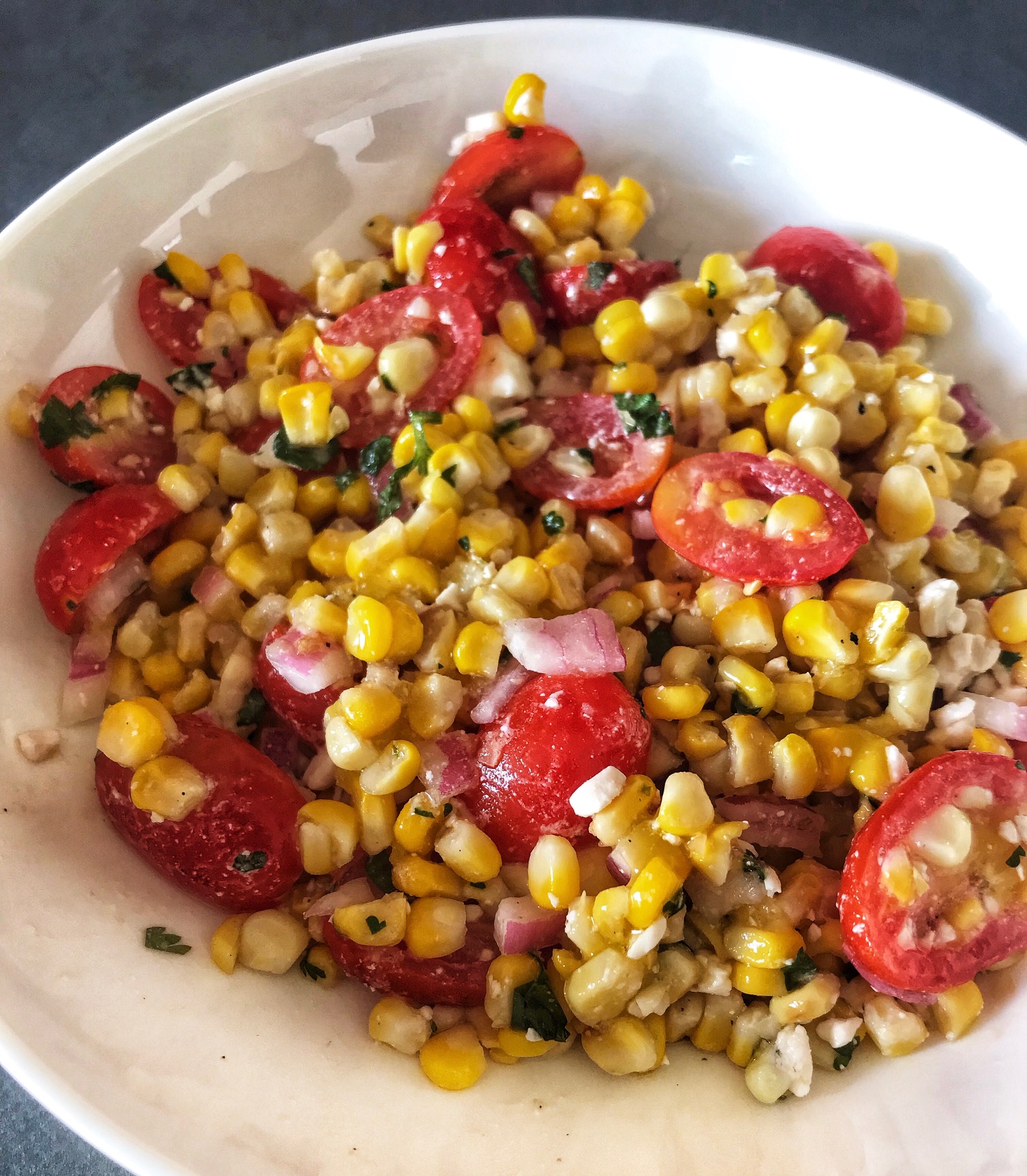 corn salad bowl with dark background