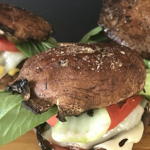 Close up of Portabello Mushroom Swiss Burgers on cutting board.