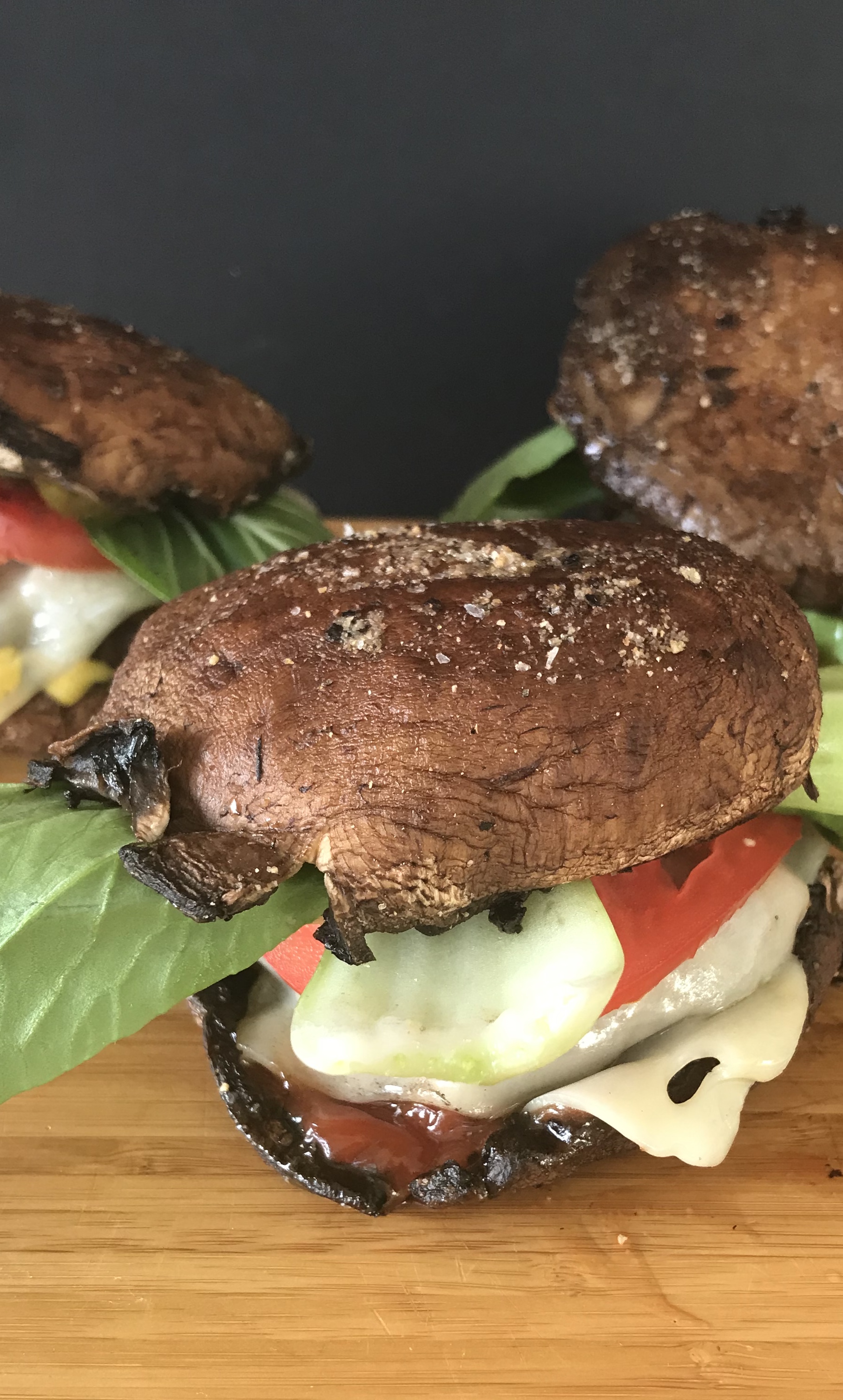 Close up of Portabello Mushroom Swiss Burgers on cutting board.